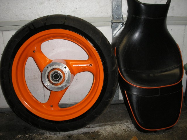 Pic of Seat Next to Orange Buell Wheel