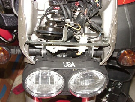 Here's an inside look. Note the original spacers behind the headlights.